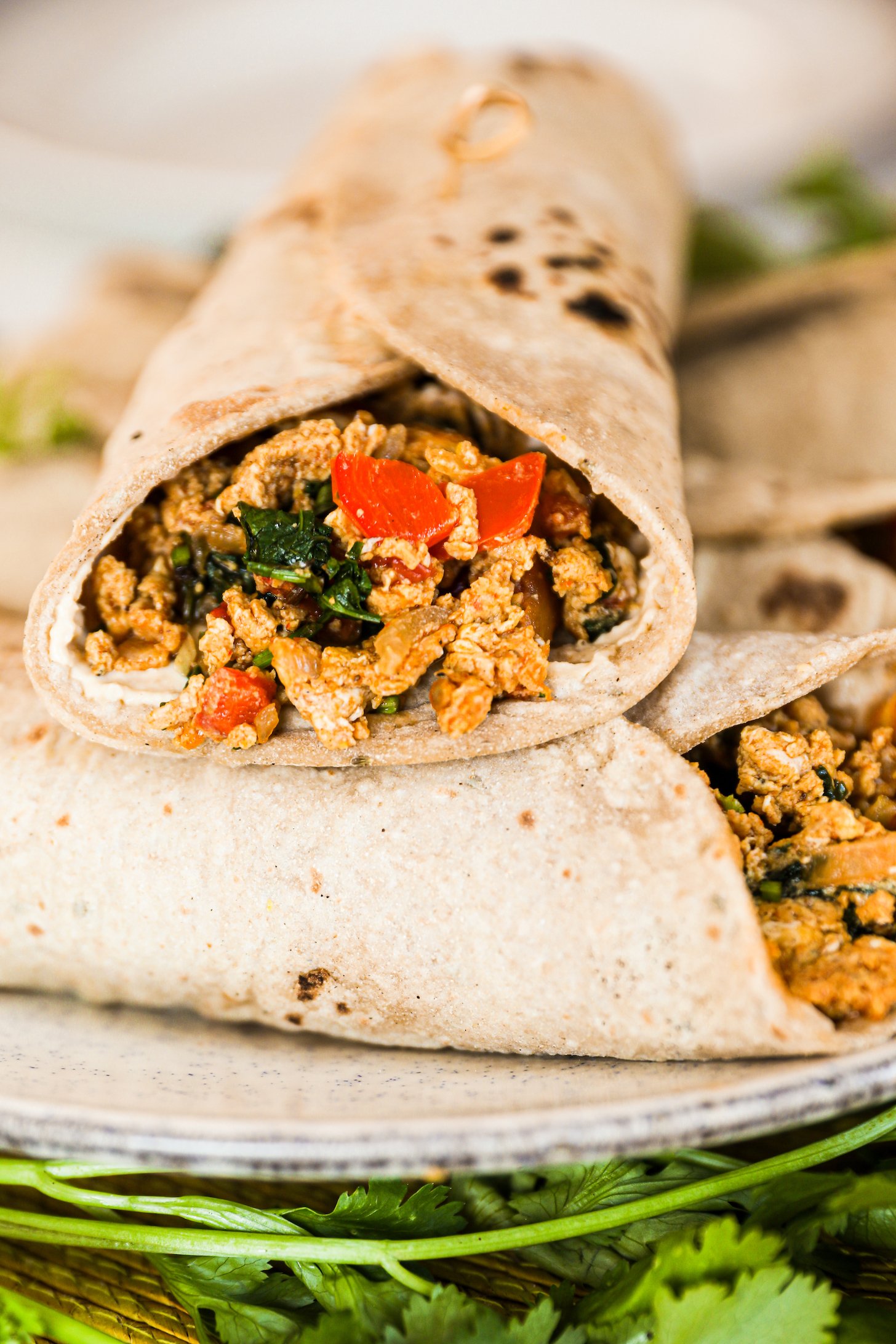 Close-up view of a single Egg Bhurji Roti Wrap placed face-up on a stack of other wraps.