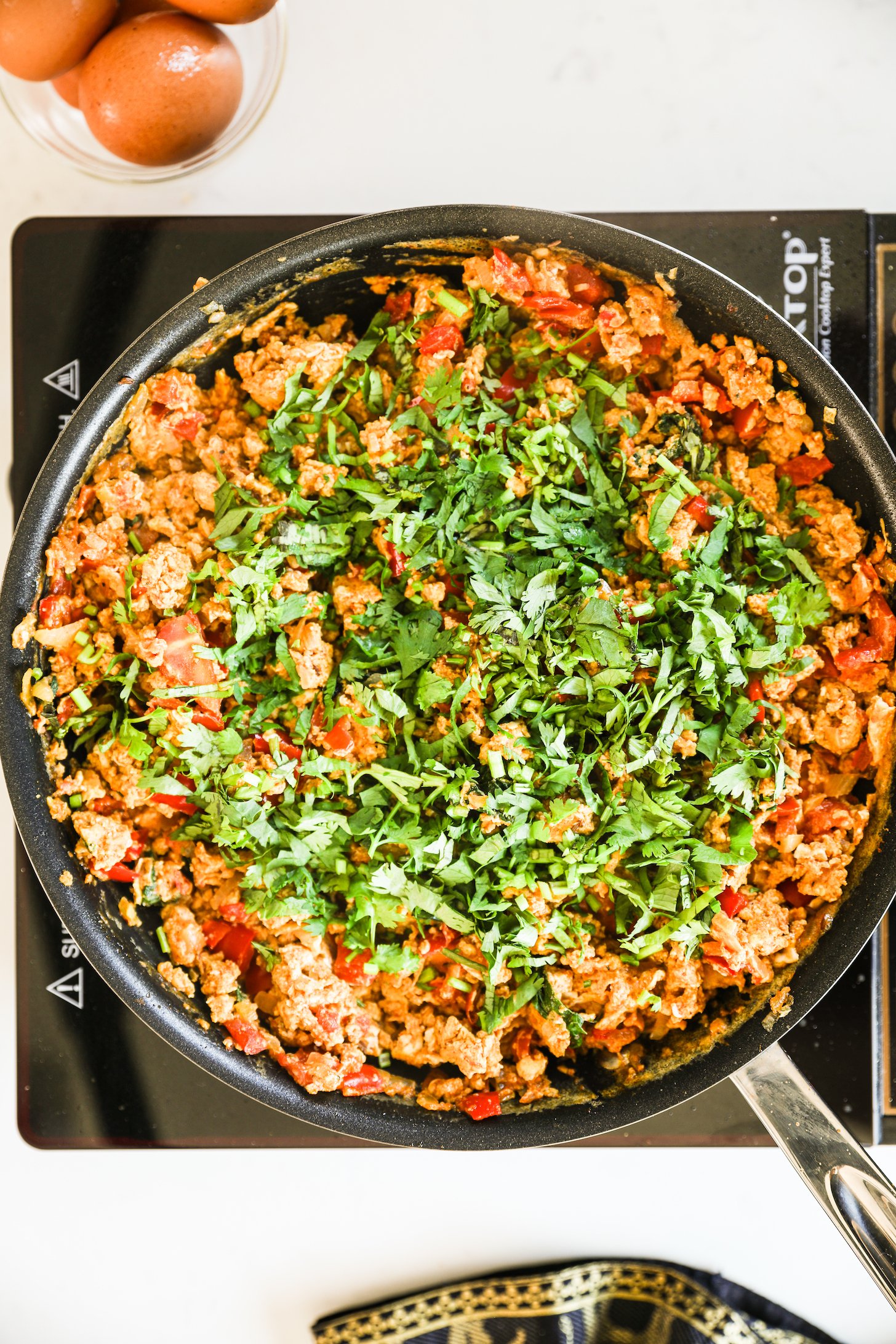 Overhead view of cooked egg bhurji topped with cilantro.