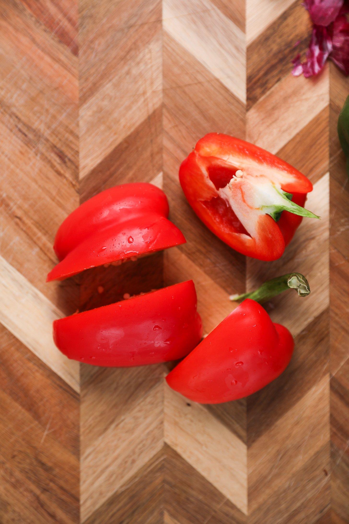 A red bell pepper sliced into quarters.