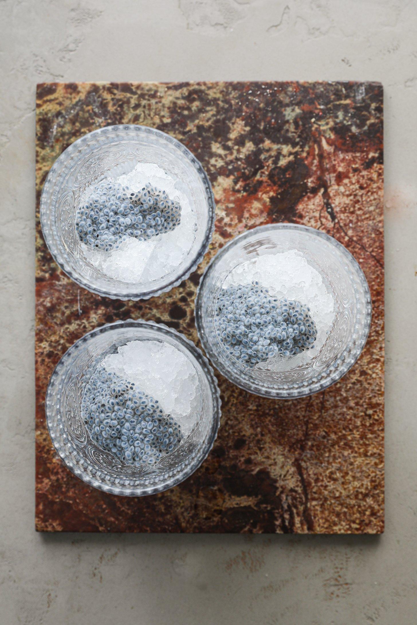 An image of 3 glasses with crushed ice and soaked basil seeds on top.