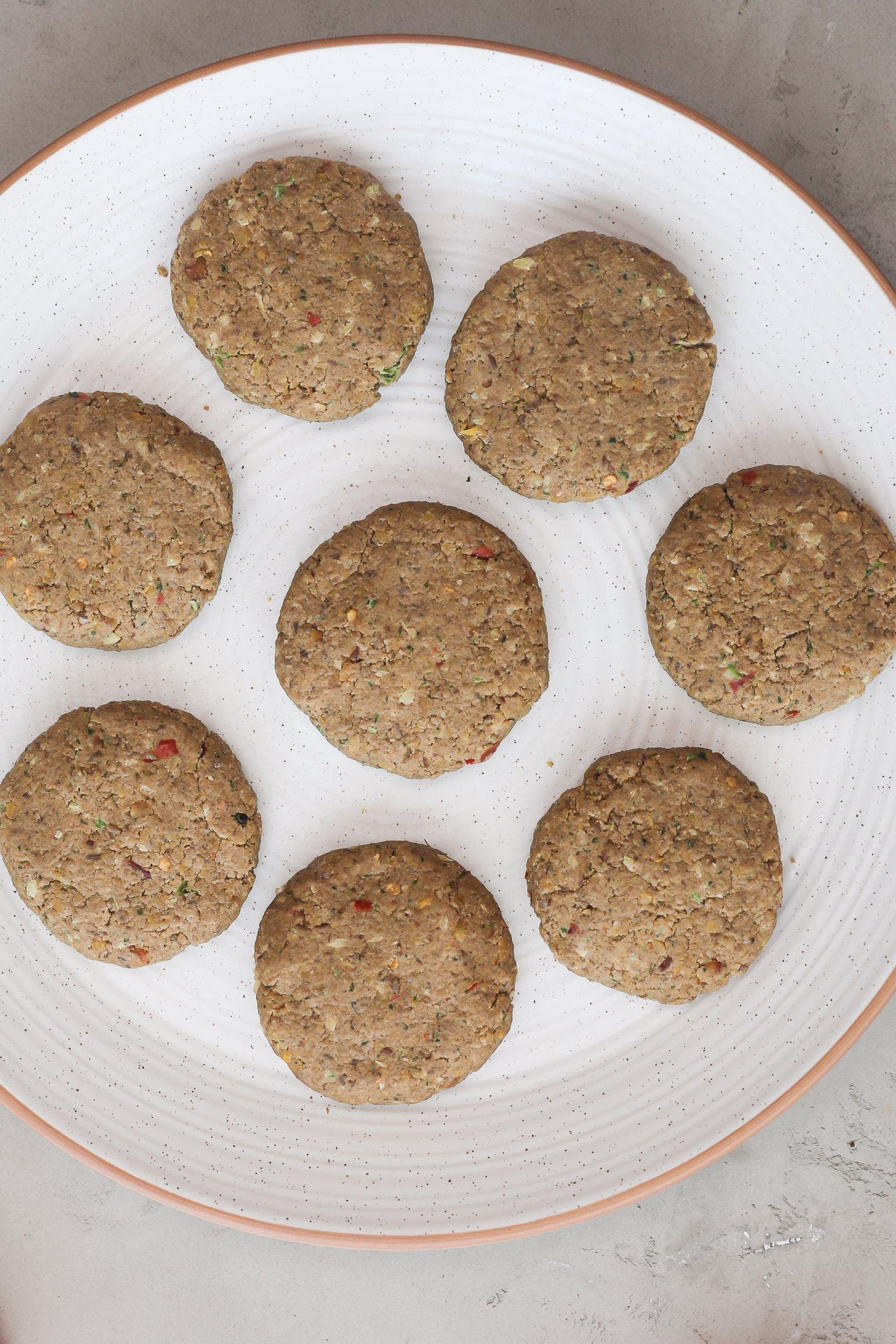 Shaped kebabs arranged on a white plate.