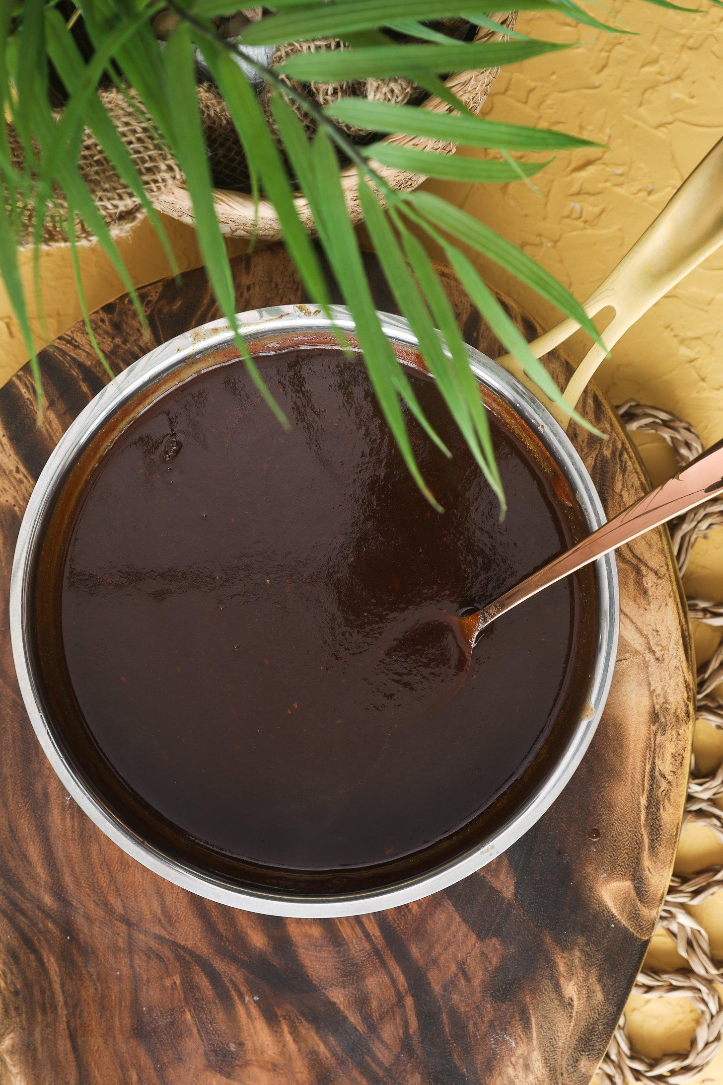 Glossy tamarind chutney in a saucepan after cooking.